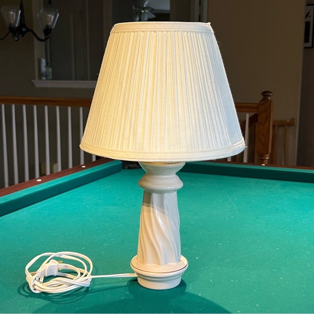 Ceramic bedside table lamp with painted gold trim and pleated shade